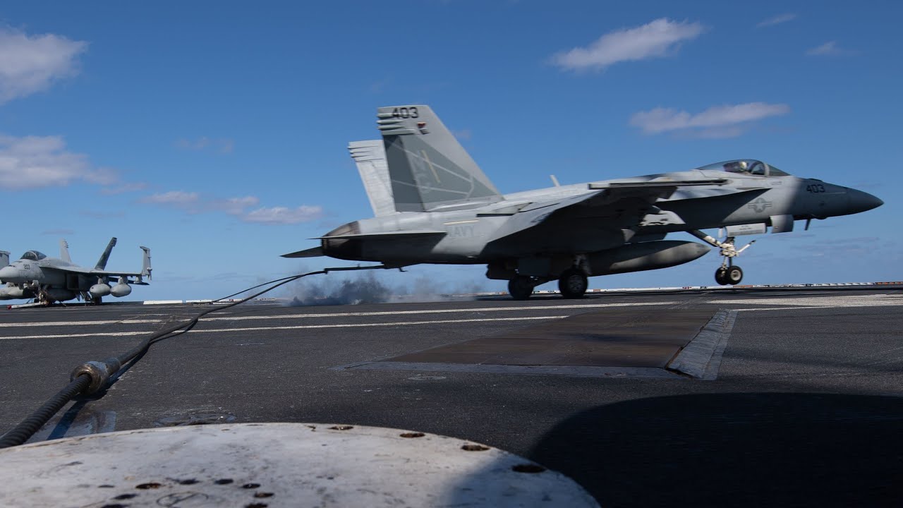 Aircraft arresting cable installation on military runway showing BAK-14 system