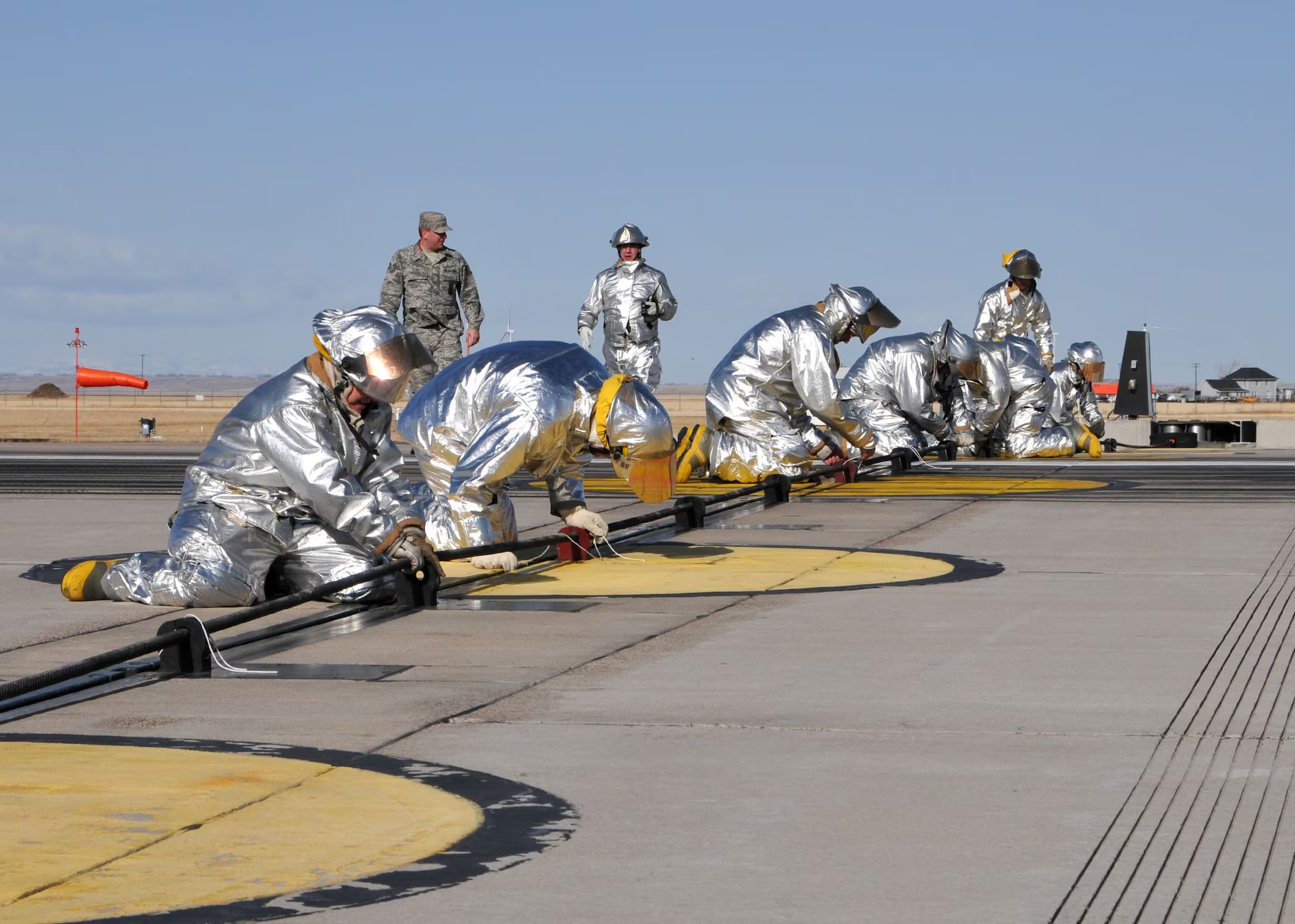 Military fighter jet engaging aircraft arresting cable during emergency landing